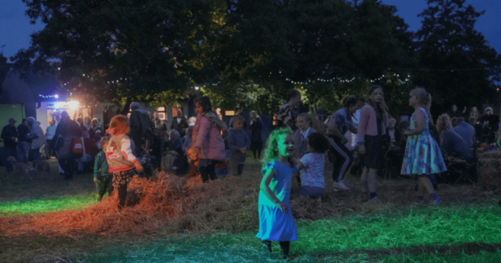 Children dancing in the evening at Party in the Park