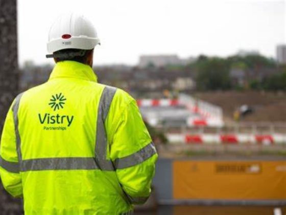 Back of man wearing Vistry Group Hi-Viz on a building site