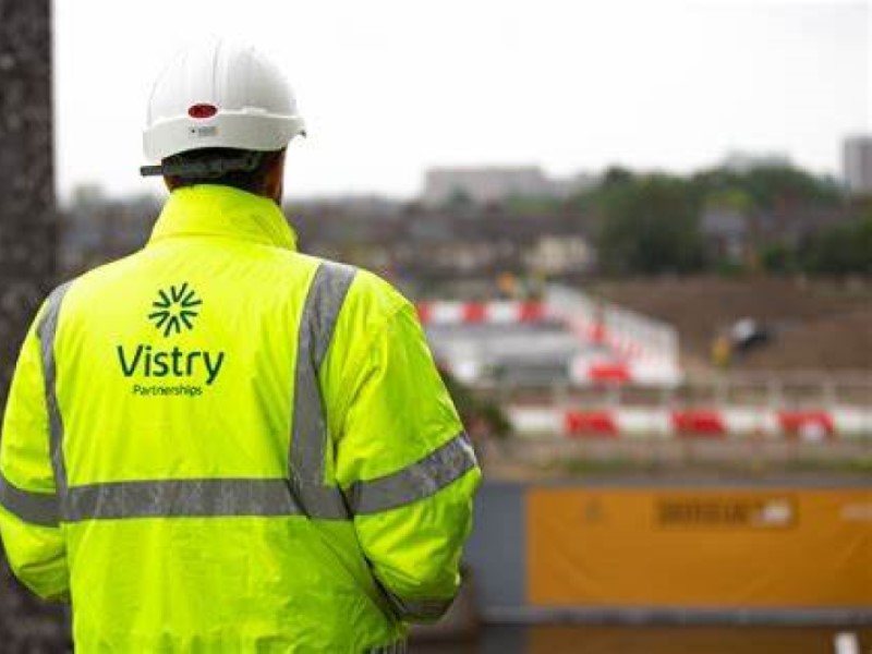 Back of man wearing Vistry Group Hi-Viz on a building site